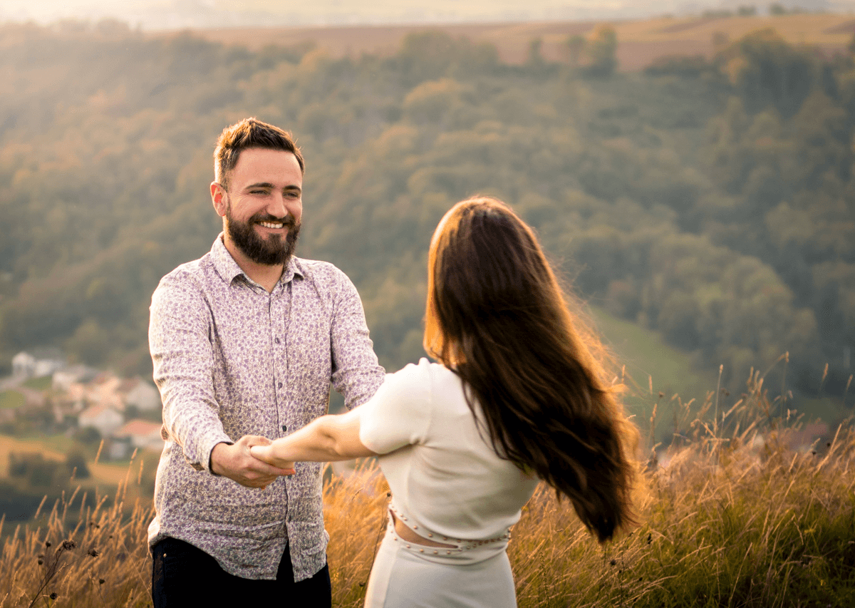 A couple holding hands in the sun