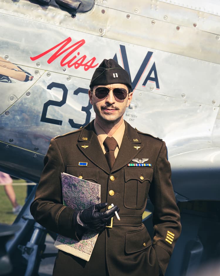A aviator standing in front of a plane