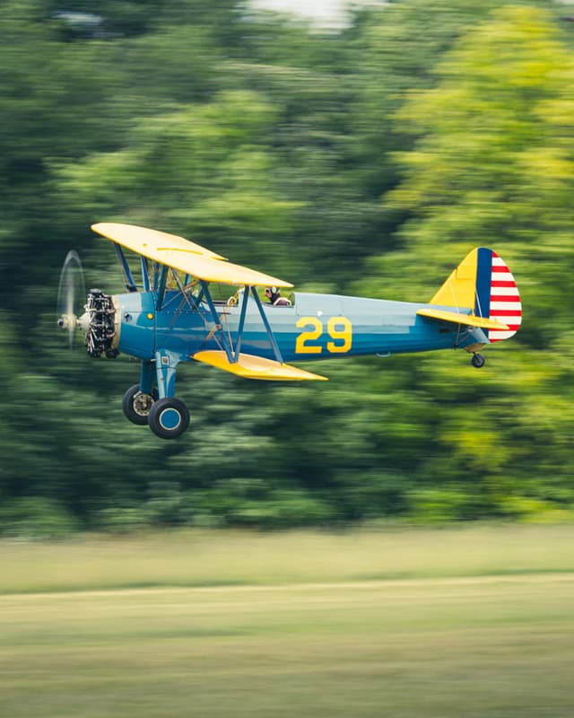 A plane flying over a field.